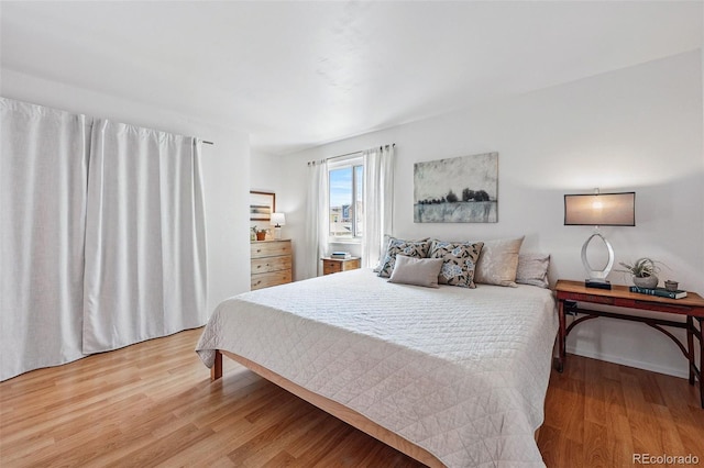 bedroom featuring wood finished floors and baseboards