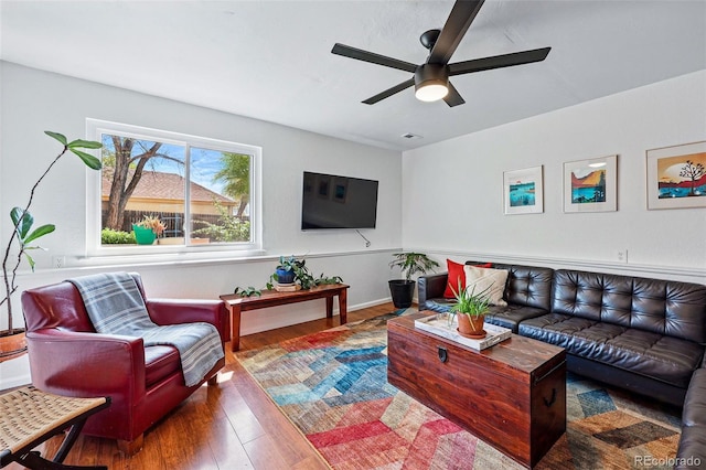 living room with wood finished floors and a ceiling fan