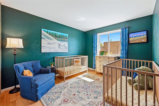 bedroom with wood finished floors and baseboards