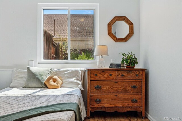 bedroom featuring wood finished floors and baseboards