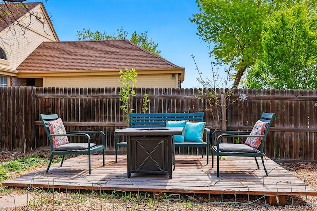 wooden deck featuring a fenced backyard