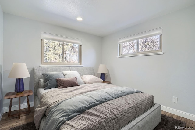 bedroom featuring recessed lighting, wood finished floors, and baseboards