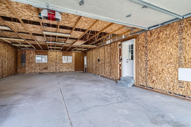 garage featuring electric panel and a garage door opener