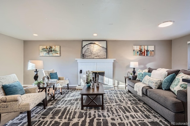 living area featuring recessed lighting, a brick fireplace, and baseboards