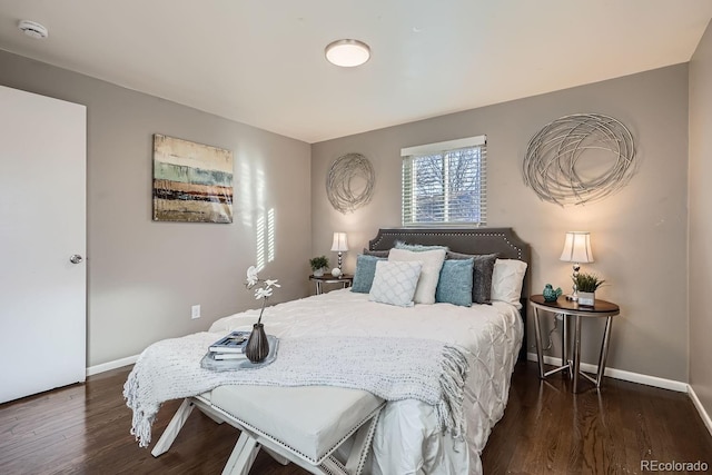 bedroom with baseboards and wood finished floors