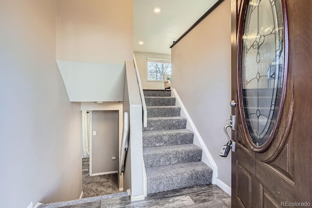 foyer with stairs and baseboards