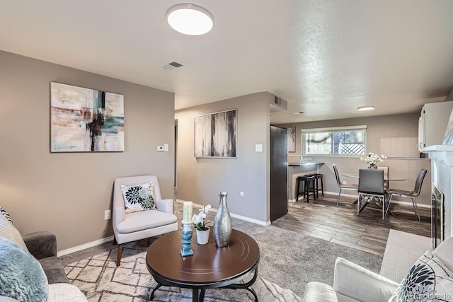 living room with visible vents and baseboards