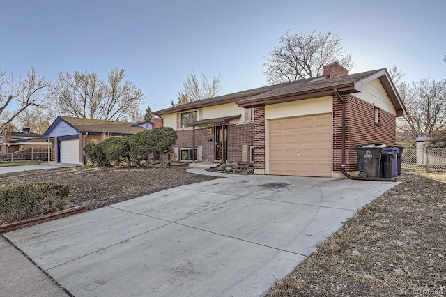 ranch-style home featuring concrete driveway, a chimney, an attached garage, fence, and brick siding