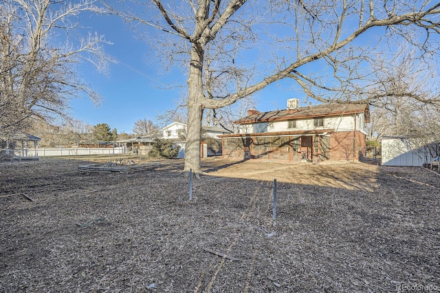 back of property featuring an outbuilding