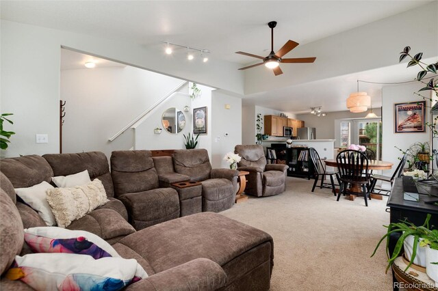 8129 Locust Dr, Littleton, CO 80125 - living room featuring light carpet, ceiling fan, track lighting, stairway, and lofted ceiling