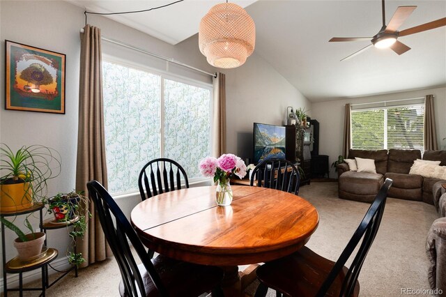 8129 Locust Dr, Littleton, CO 80125 - dining space featuring vaulted ceiling, a ceiling fan, and light colored carpet