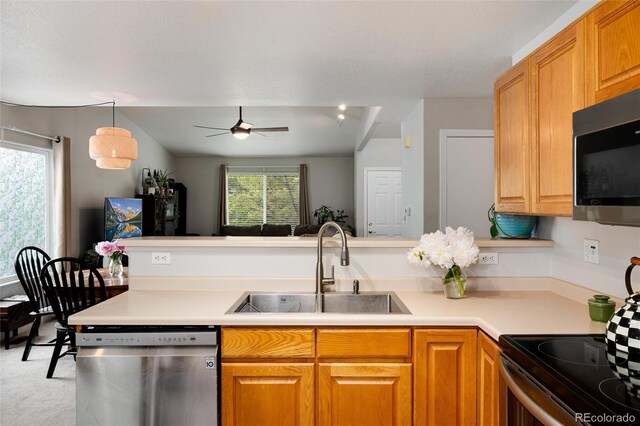 8129 Locust Dr, Littleton, CO 80125 - kitchen featuring appliances with stainless steel finishes, a sink, a ceiling fan, light countertops, and open floor plan