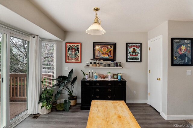 8129 Locust Dr, Littleton, CO 80125 - dining space with baseboards and dark wood-style flooring