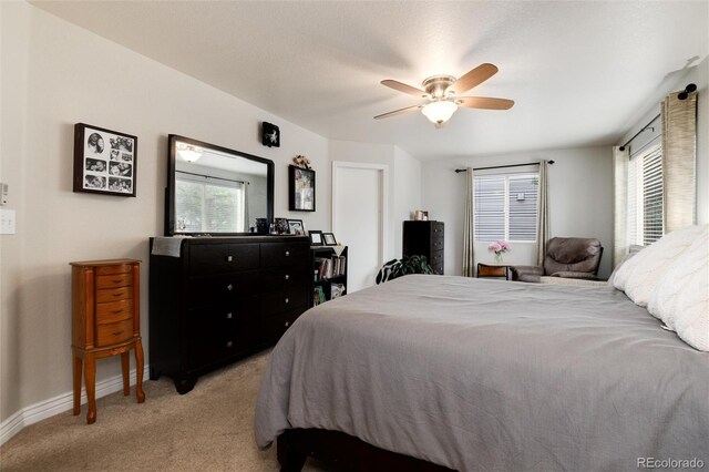 8129 Locust Dr, Littleton, CO 80125 - bedroom with light colored carpet, multiple windows, baseboards, and a ceiling fan