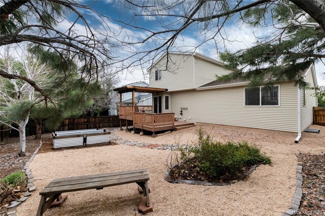 8129 Locust Dr, Littleton, CO 80125 - back of property featuring a deck and a patio