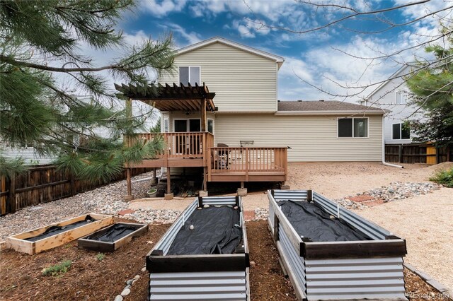 8129 Locust Dr, Littleton, CO 80125 - rear view of property featuring a vegetable garden, a wooden deck, and a pergola