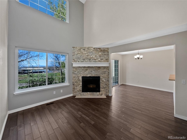 2418 W 82nd Pl Unit D, Westminster, CO 80031 - unfurnished living room with a chandelier, a towering ceiling, plenty of natural light, and wood finished floors