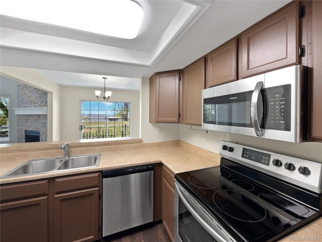 2418 W 82nd Pl Unit D, Westminster, CO 80031 - kitchen with a sink, stainless steel appliances, a notable chandelier, and plenty of natural light