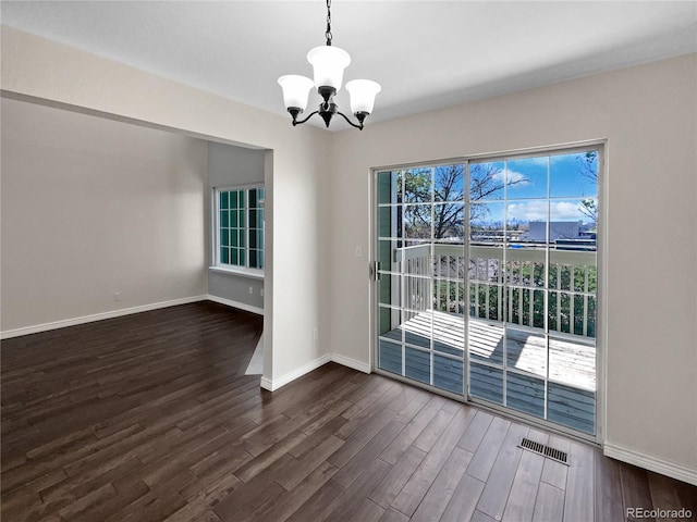 2418 W 82nd Pl Unit D, Westminster, CO 80031 - unfurnished dining area featuring an inviting chandelier, visible vents, baseboards, and dark wood-style floors