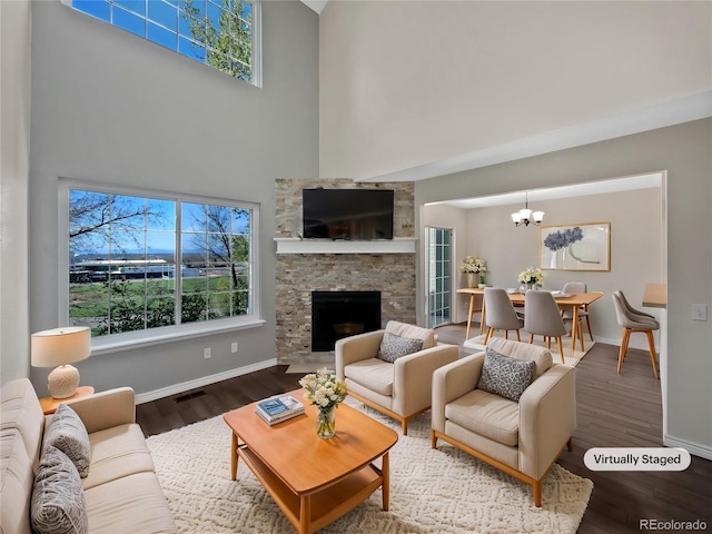 2418 W 82nd Pl Unit D, Westminster, CO 80031 - living area with a high ceiling, a chandelier, a fireplace, and a healthy amount of sunlight