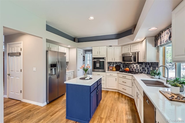 5305 W Lake Pl, Littleton, CO 80123 - kitchen featuring stainless steel appliances, a sink, light countertops, white cabinetry, and recessed lighting