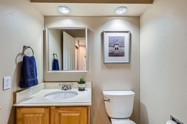 5305 W Lake Pl, Littleton, CO 80123 - bathroom featuring toilet, vanity, and a textured wall