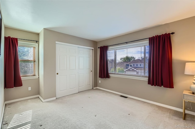 5305 W Lake Pl, Littleton, CO 80123 - unfurnished bedroom featuring baseboards, multiple windows, and carpet floors