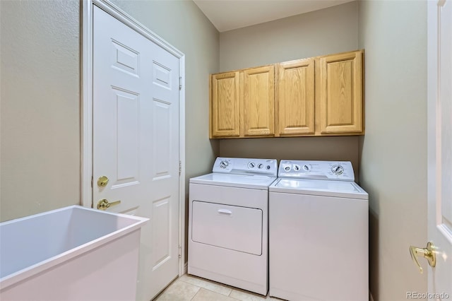 5305 W Lake Pl, Littleton, CO 80123 - laundry area with cabinet space, washer and dryer, and light tile patterned floors
