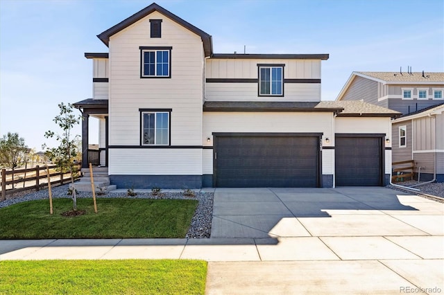 view of front of home with a front yard and a garage