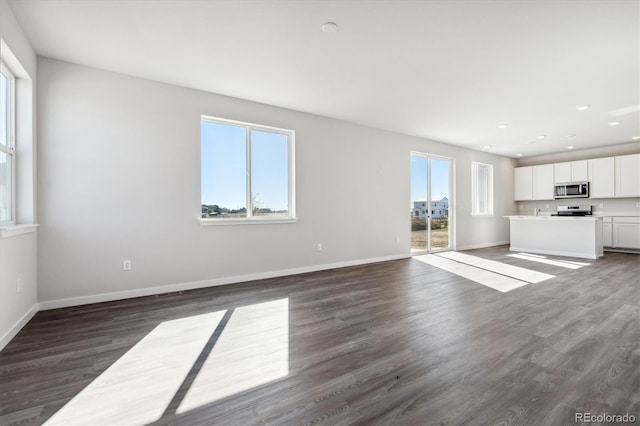 unfurnished living room with dark hardwood / wood-style flooring