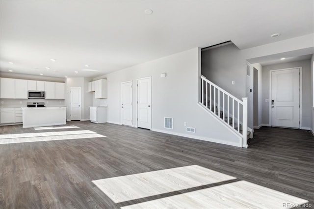 unfurnished living room with wood-type flooring