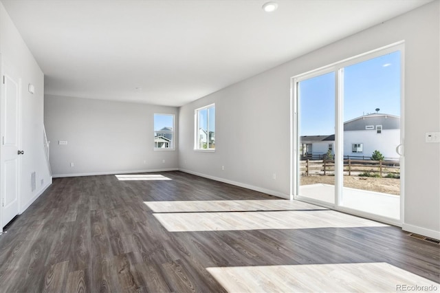 unfurnished room with dark wood-type flooring