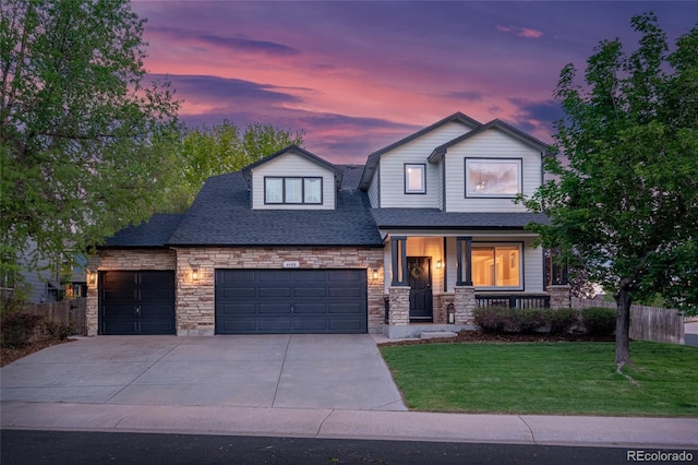 6488 Tilbury Ave, Firestone, CO 80504 - view of front of property with stone siding, a porch, a garage, concrete driveway, and roof with shingles