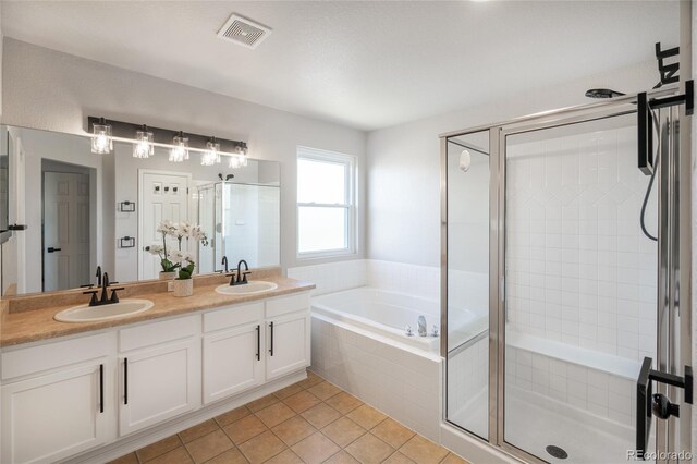 6488 Tilbury Ave, Firestone, CO 80504 - bathroom with a stall shower, a garden tub, double vanity, and tile patterned floors