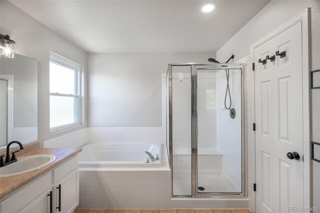 6488 Tilbury Ave, Firestone, CO 80504 - bathroom featuring a shower stall, a garden tub, vanity, and recessed lighting