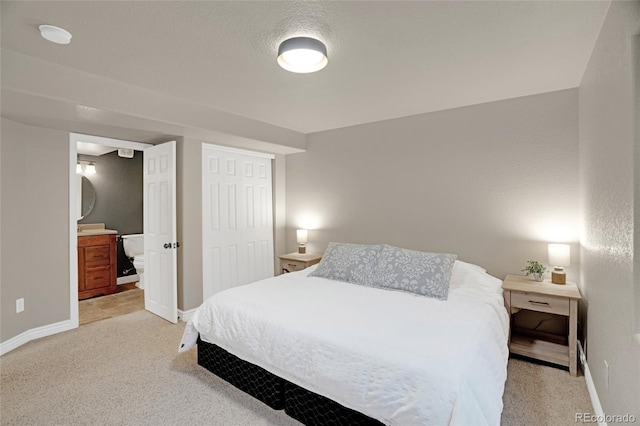 6488 Tilbury Ave, Firestone, CO 80504 - bedroom featuring light carpet, baseboards, a closet, and ensuite bath