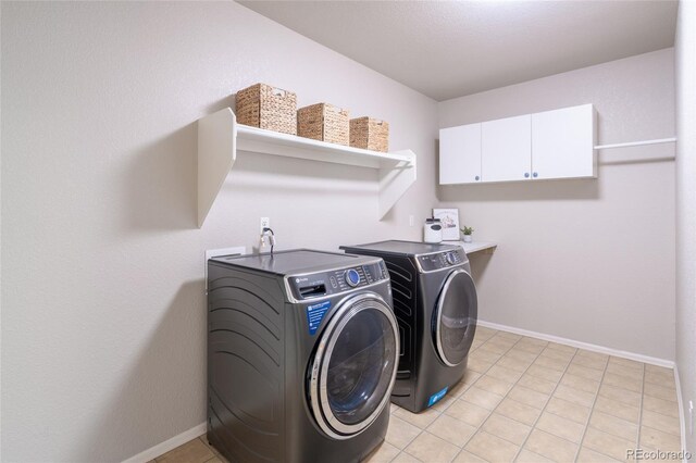 6488 Tilbury Ave, Firestone, CO 80504 - laundry room with washing machine and clothes dryer, cabinet space, baseboards, and light tile patterned flooring