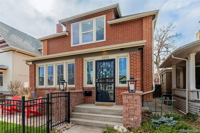 view of front of home featuring brick siding and fence