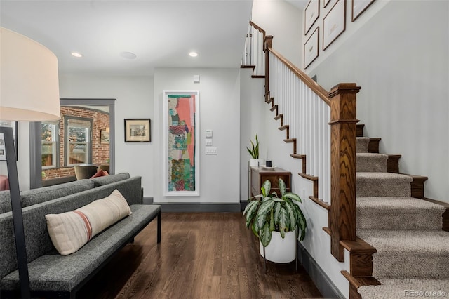 interior space featuring recessed lighting, baseboards, dark wood-style flooring, and stairs