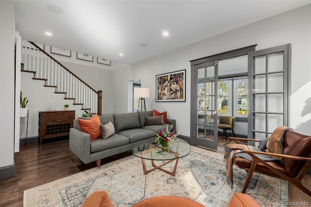 living area with recessed lighting, baseboards, wood finished floors, and stairs