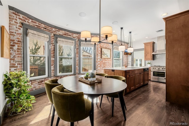 dining room with recessed lighting, visible vents, dark wood-type flooring, and brick wall