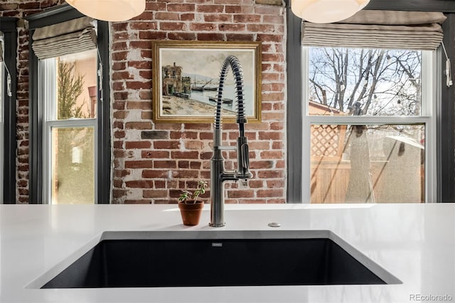 interior details with light countertops and a sink