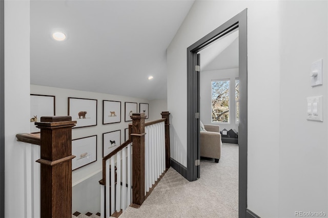 corridor featuring baseboards, lofted ceiling, an upstairs landing, carpet flooring, and recessed lighting