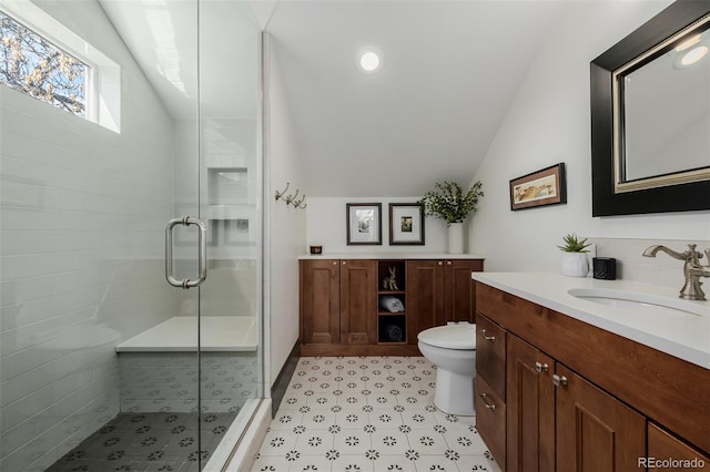 bathroom featuring toilet, a stall shower, recessed lighting, vanity, and vaulted ceiling