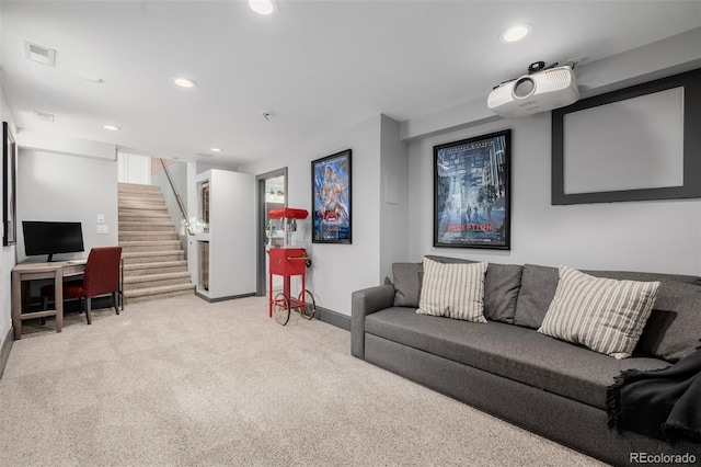 carpeted living area with recessed lighting, visible vents, baseboards, and stairway