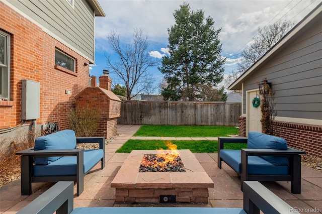 view of patio with an outdoor living space with a fire pit and fence