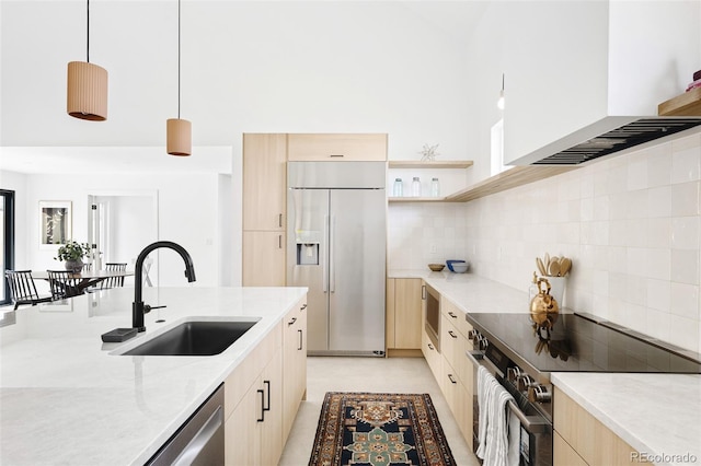 kitchen featuring built in appliances, modern cabinets, light brown cabinetry, and a sink