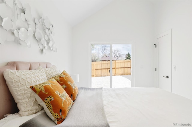 bedroom with lofted ceiling and access to exterior