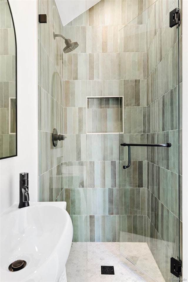 full bath with a shower stall and a sink