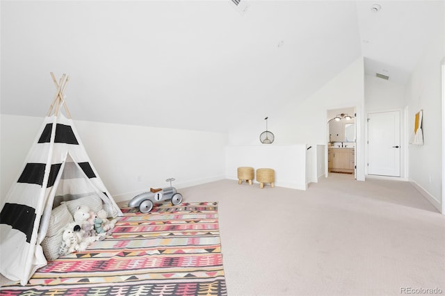 unfurnished bedroom featuring lofted ceiling, visible vents, light carpet, connected bathroom, and baseboards
